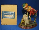 GERMAN TIN LITHO WEIGHT LIFTING CLOWN