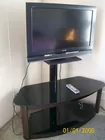 TV & stand by Merritt Family Auctions