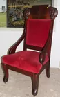 Wood framed chair with faces