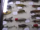 Glasss case full of collectible fishing lures