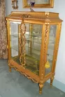Gilded French Showcase with gilded wreaths on fron