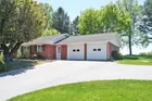 A brick two (2) bedroom rancher house w/ garage