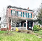 A 2-1/2 story brick Victorian house w/ garage