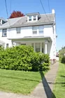 A 2-1/2 story stucco semi-detached duplex