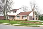 A brick & vinyl sided 2-story 3-bedroom house