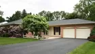 A brick 5-bedroom 3-bath ranch house w/ garage