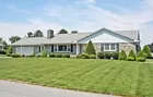 A stone 3-bedroom ranch house w/ attached garage