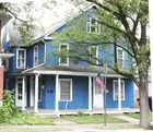 A 2-1/2 story frame-sided two (2) unit duplex