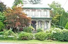 A 2-1/2 story frame victorian style house