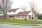 A brick & vinyl sided 2-story 3-bedroom house