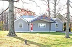 A vinyl sided three (3) bedroom ranch style house