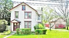 A 2-1/2 story frame house w/ garages & workshop