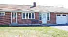A brick 3-bedroom ranch style house w/ garage