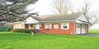 A brick 2-bedroom ranch house w/ oversized garage